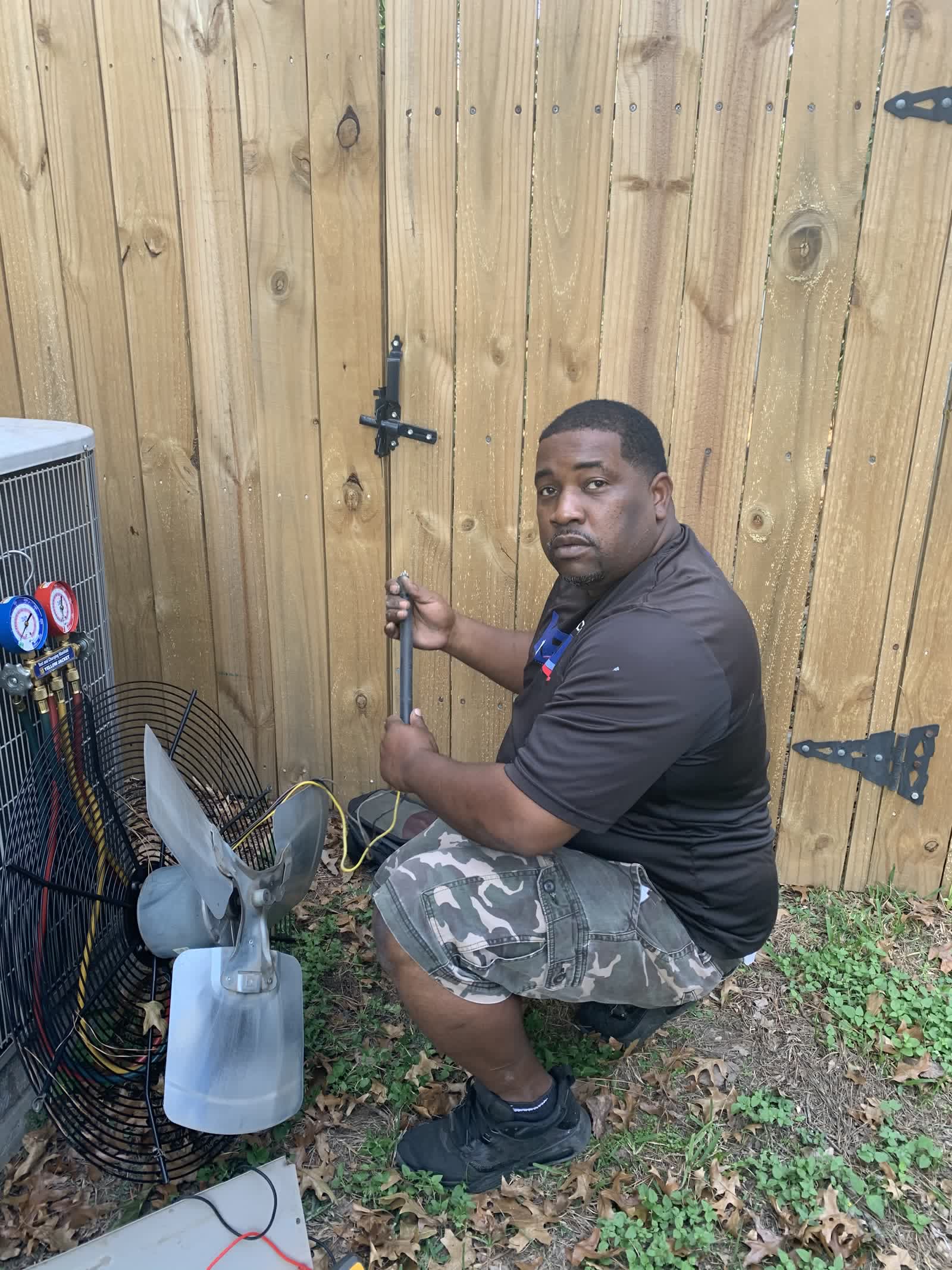 KRM technician checking an outdoor condenser